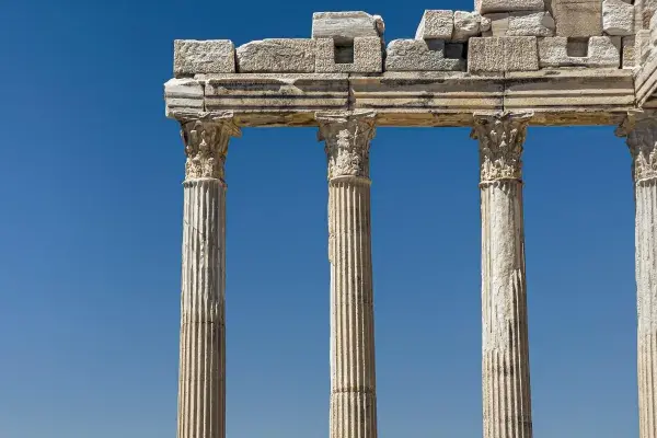 Ancient Greek ruins with standing Corinthian columns.