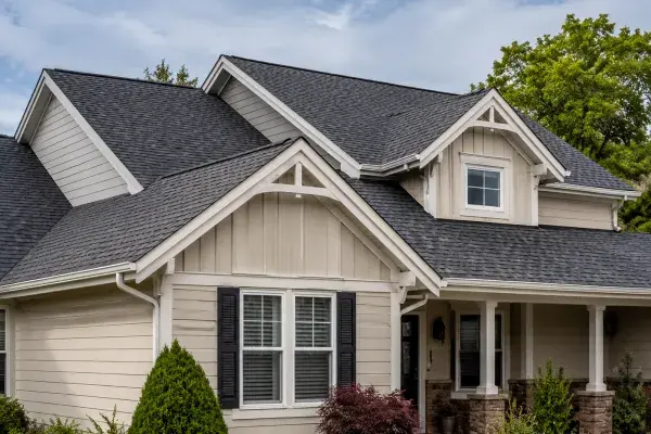 Overlapping gable rooflines showing ridge peaks, shingle courses, and white rake trim.