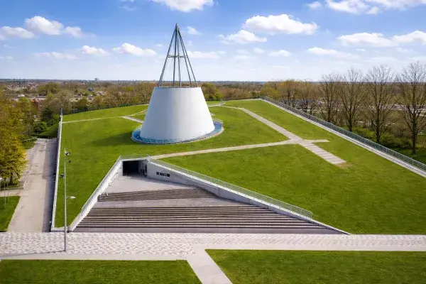 TU Delft Library with grass roof and cone skylight viewed from a higher angle.