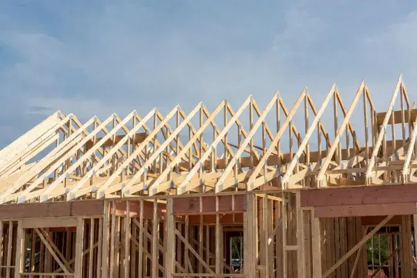  Row of prefabricated Fink roof trusses installed on a wood-framed residential structure.